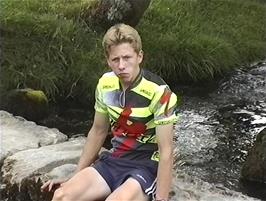 Ryan waits for the slower walkers on a footbridge over the Malham Beck near Malham Cove